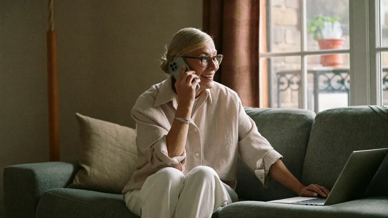 Homeowner on the phone booking a window quote appointment at home